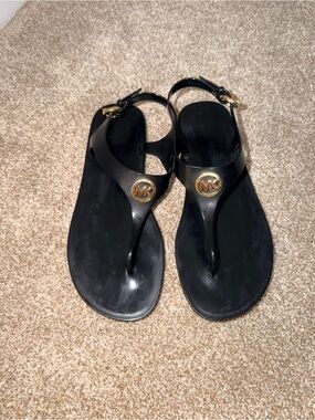 Michael Kors Black Thong Sandals with Gold Logo Medallion